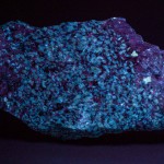Norbergite and corundum fluorescing under longwave ultraviolet light